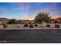 Inviting front exterior showcases lush landscaping and a circular driveway at dusk at 26204 S Washington St, Chandler, AZ 85249