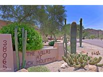 Property entrance showcases desert landscaping, community sign, and neighborhood address at 38065 N Cave Creek Rd # 2, Cave Creek, AZ 85331