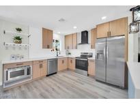 Modern kitchen featuring stainless steel appliances, light wood cabinetry, and stylish countertops at 5236 S 19Th Ave, Phoenix, AZ 85041