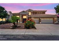 Stunning home with a three-car garage, desert landscaping, and a tile roof in a desirable neighborhood at 6376 W Louise Dr, Glendale, AZ 85310