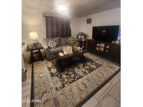 Cozy living room featuring comfortable seating, a decorative rug, and a modern entertainment center at 6733 W Sherri Jean Ln, Peoria, AZ 85382