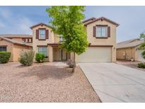 Charming two-story home with a two-car garage and desert landscaping in the front yard at 694 W Desert Seasons Dr, San Tan Valley, AZ 85143
