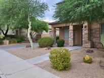 Charming home featuring stone accents, desert landscaping, and a welcoming covered entrance at 8340 W Staghorn Rd, Peoria, AZ 85383
