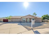 Charming single-story home with a well-maintained front yard and a two-car garage at 12434 S Ki Cir, Phoenix, AZ 85044