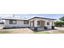 Stylish single-story home with a charming front porch and modern color palette at 1427 W 6Th Dr, Mesa, AZ 85202