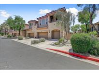 Inviting townhome complex showcases manicured landscaping and private garage entrances at 16420 N Thompson Peak Pkwy # 2101, Scottsdale, AZ 85260
