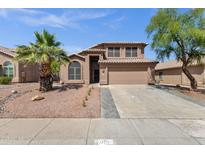 Charming two-story home with a desert landscape, palm tree, and tile roof under a clear sky at 17204 E Kensington Pl, Fountain Hills, AZ 85268