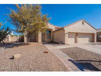 Charming single-story home featuring a well-manicured front yard, desert landscaping, and a two-car garage at 1807 W Canary Way, Chandler, AZ 85286