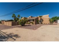 Inviting home featuring desert landscaping, mature trees, and a unique architectural design at 1953 E Presidio Rd, Phoenix, AZ 85022