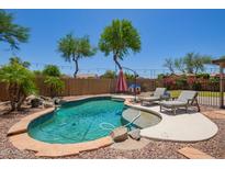 Inviting backyard pool features beautiful landscaping and lounge chairs for relaxing by the water at 1991 S Bahama Dr, Gilbert, AZ 85295
