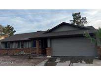Charming single-story home with an attached two-car garage and well-maintained front yard at 2215 E Dragoon Ave, Mesa, AZ 85204