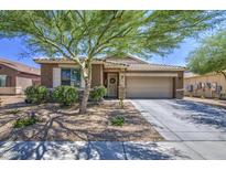 Charming single-story home featuring a well-manicured front yard and a two-car garage at 23781 W Mohave St, Buckeye, AZ 85326
