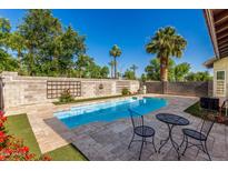 Sparkling pool surrounded by lush landscaping, perfect for outdoor enjoyment at 3685 N 141St Dr, Goodyear, AZ 85395