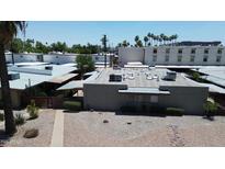 Aerial view of a modern house with desert landscaping, a flat roof, and air conditioning units at 411 W Colter St # A, Phoenix, AZ 85013