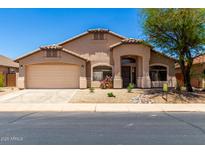 Charming single-story home with a two-car garage and desert landscaping at 42196 W Chisholm Dr, Maricopa, AZ 85138