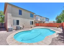 Backyard pool with a stone tile surround, mature landscaping, and a low block wall at 45113 W Buckhorn Trl, Maricopa, AZ 85139
