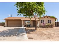 Charming single-story home with a two-car garage, mature landscaping, and a welcoming front yard at 4712 W Juniper Ave, Glendale, AZ 85306