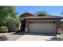 Charming single-story home featuring a well-maintained yard and a spacious two-car garage at 5374 N Ormondo Way, Litchfield Park, AZ 85340