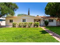 Charming single-story home featuring a well-manicured lawn and desert landscaping, perfect for curb appeal at 606 W 15Th St, Tempe, AZ 85281