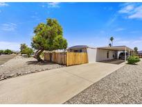 Charming single-story home with covered parking, complemented by mature trees and a low-maintenance landscape at 7711 E Farmdale Ave, Mesa, AZ 85208