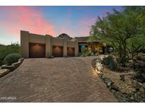 Stunning desert home boasts a private drive, three-car garage and landscaped front yard at 7731 E Soaring Eagle Way, Scottsdale, AZ 85266