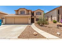 Inviting two-story home with a large two car garage and a beautifully landscaped front yard at 82 N 221St Ave, Buckeye, AZ 85326