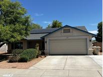 Charming single-story home featuring a two-car garage, solar panels, and well-maintained landscaping at 8540 W Ocotillo Rd, Glendale, AZ 85305
