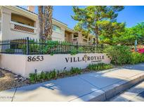 Well-maintained Villa Royale condo with lush landscaping and black metal fence at 8653 E Royal Palm Rd # 1030, Scottsdale, AZ 85258
