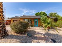 Charming home featuring desert landscaping with a bright turquoise front door and stone walkway at 8738 E Vista Dr, Scottsdale, AZ 85250