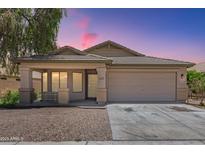 Charming single-story home featuring a well-maintained front yard and a two-car garage at 16783 W Taylor St, Goodyear, AZ 85338