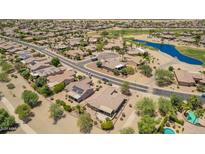 Community aerial view showcasing lush golf course, lake, and well-maintained homes at 17359 W Calistoga Dr, Surprise, AZ 85387