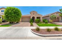 Charming single-story home featuring low maintenance landscaping, a two-car garage, and stylish curb appeal at 20563 W Edgemont Ave, Buckeye, AZ 85396