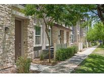 Charming townhome with stone accents, a well-maintained lawn, and a sidewalk in a desirable community at 2313 E Hidalgo Ave, Phoenix, AZ 85040