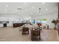 Bright living room with vaulted ceiling, ceiling fan, modern furniture and view of the kitchen at 3220 W Frankfurt Dr, Chandler, AZ 85226