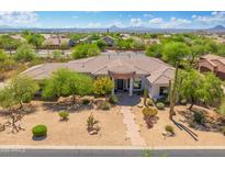 Charming desert home with mature trees, landscaping, a stone walkway, and a prominent portico at 3946 N Pinnacle Hills Cir, Mesa, AZ 85207