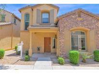 Charming two-story home featuring a stone facade, a covered entryway, and desert landscaping at 3977 E Cat Balue Dr, Phoenix, AZ 85050