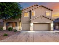 Charming two-story home with a three-car garage and well-maintained landscaping at 46065 W Meadows Ln, Maricopa, AZ 85139