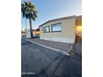 Charming manufactured home featuring a covered parking area and a desert-style landscaped front at 5601 W Missouri Ave # 63, Glendale, AZ 85301