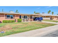 Charming single-story home with well-maintained lawn and covered parking, perfect for comfortable living at 10873 W Clair Dr, Sun City, AZ 85351