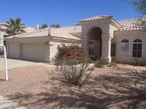 Inviting single-story home with a well-manicured yard, a tile roof, and a spacious three-car garage at 11109 W Amelia Ave, Avondale, AZ 85392