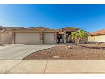 Charming single-story home featuring a well-manicured desert landscape, tile roof, and a spacious two-car garage at 11312 E Newcastle Ave, Mesa, AZ 85209