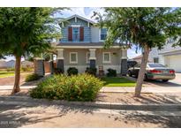 Charming two-story home featuring a covered porch, well-maintained landscaping, and a welcoming facade at 1232 S 120Th Ln, Avondale, AZ 85323