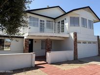 Charming two-story home with brick accents, balcony, and attached two-car garage at 13438 N 18Th Ln, Phoenix, AZ 85029