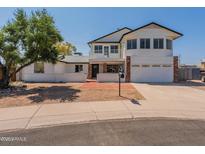 Inviting two-story home featuring a balcony, brick accents, and attached two-car garage at 13438 N 18Th Ln, Phoenix, AZ 85029