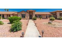 Charming single-story home featuring a beautifully landscaped front yard with a concrete walkway and desert landscaping at 13644 W Aleppo Dr, Sun City West, AZ 85375