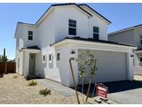 Charming two-story home featuring a gray two-car garage, light green door, and desert landscaping at 1552 N Pueblo Dr, Apache Junction, AZ 85120