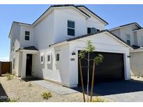 Charming two-story home with a black garage door, neutral color scheme, and well-manicured desert landscaping at 1576 N Pueblo Dr, Apache Junction, AZ 85120