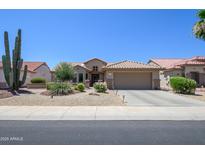 Charming home featuring a neutral color scheme, desert landscaping, and a spacious two-car garage at 16287 W Willow Creek Ln, Surprise, AZ 85374