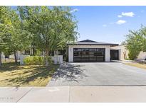 Charming single-story home with a modern garage door and well-maintained landscaping at 1861 W Navarro Ave, Mesa, AZ 85202