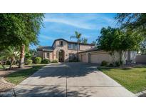Stunning two-story home with arched entry, mature trees and an attached two-car garage at 1991 W Bartlett Ct, Chandler, AZ 85248